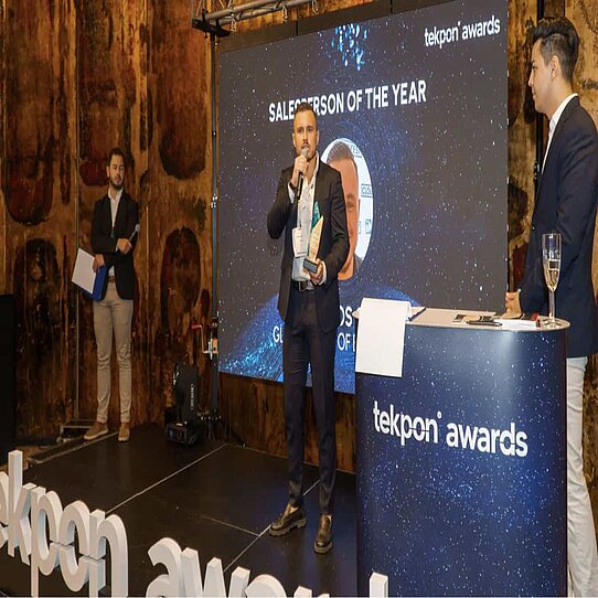 Dragos Gal receiving his "Salesperson of the Year" Award Dragos Gal collecting his Tekpon award